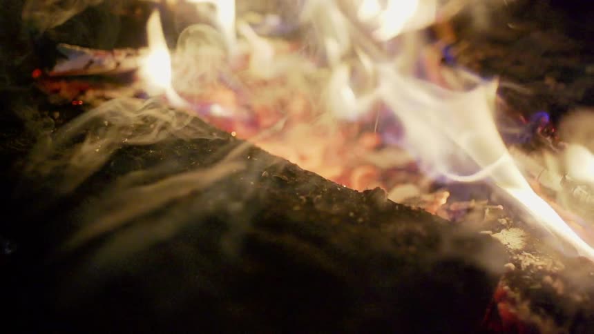 A fire burns with blue and orange glow