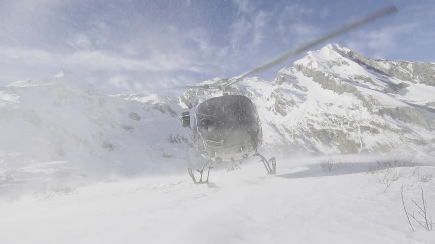 A helicopter landing in the snow
