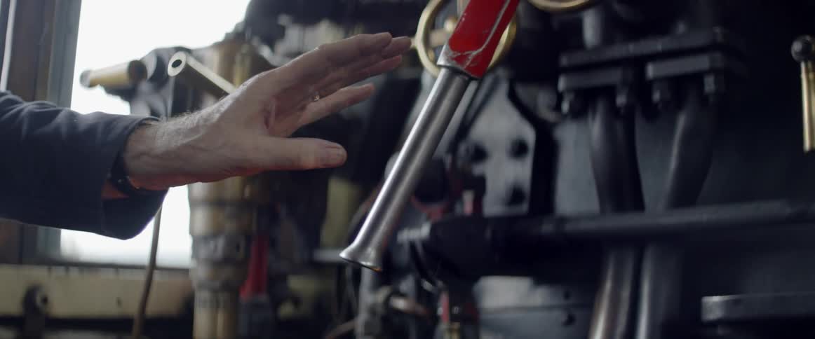 A man reaches for a nozzle