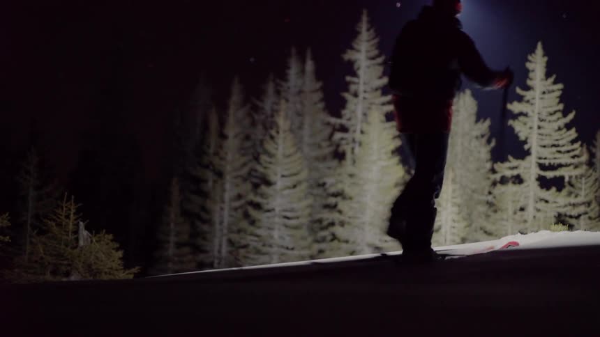 A hiker climbs with snowshoes