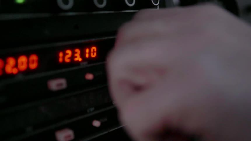 A person is operating the panel of a vehicle