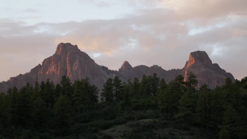 Trees with rocky hills at sunset