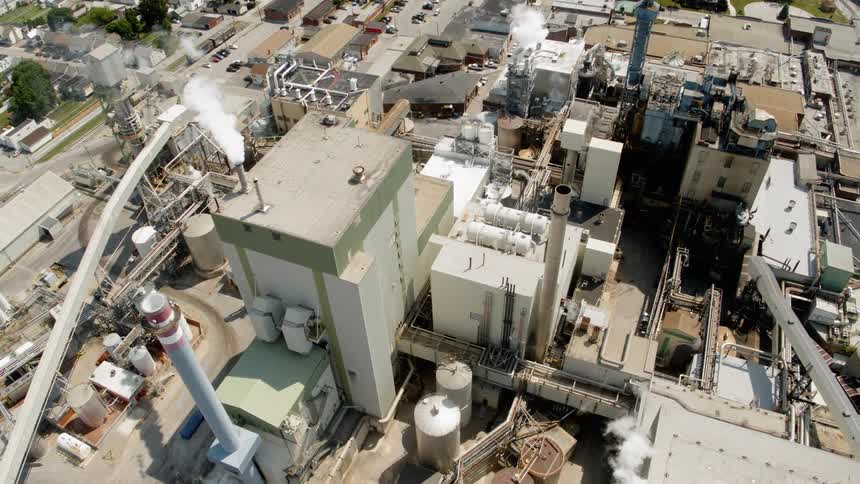 Factories puff out smoke from their chimneys