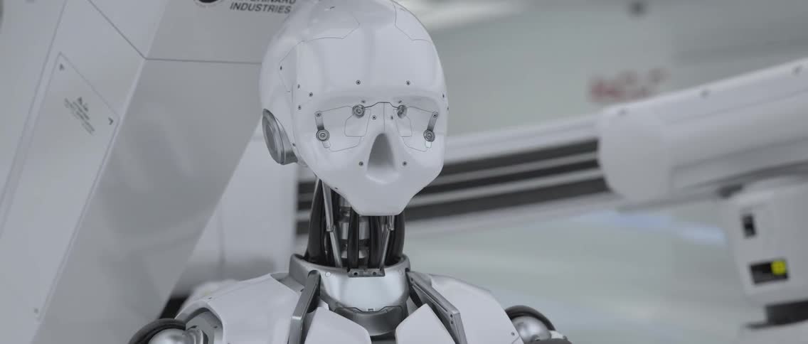 A white robot sits in a factory
