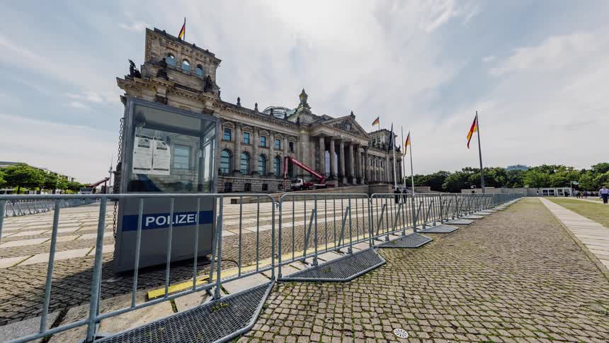 Crowds move through a barricaded area near Berlin Reichstag