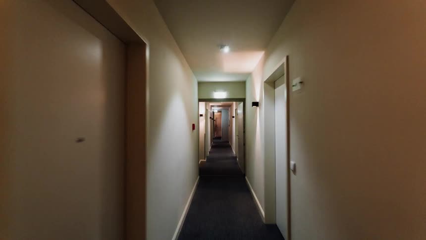 Traversing a narrow, door lined hallway