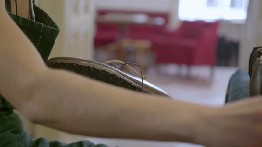 Worker polishes a leather shoe
