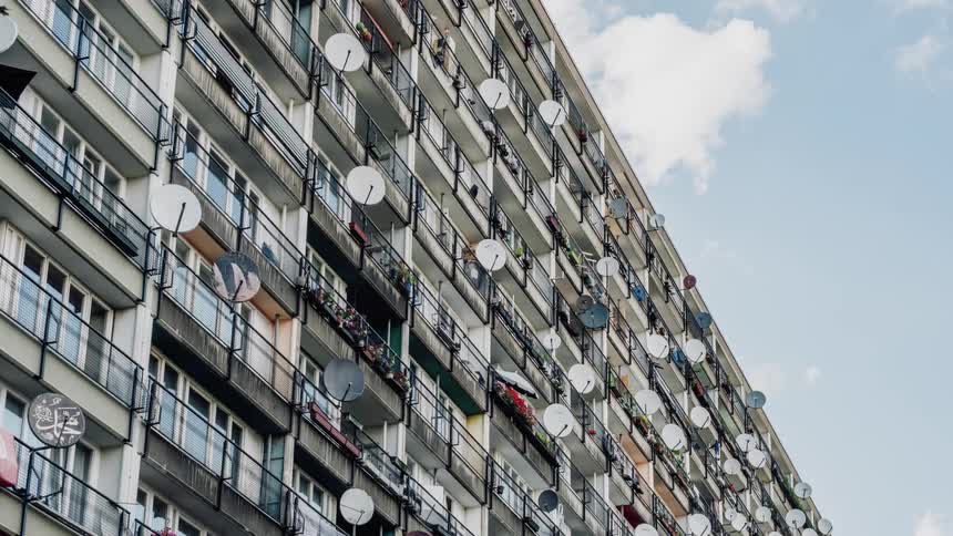 Satellite dishes mounted on apartment railings