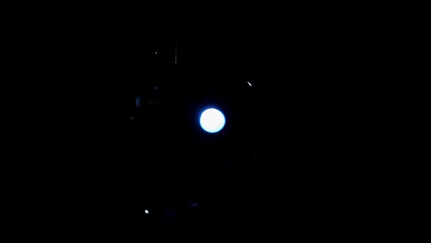 A light flashes bright blue and purple