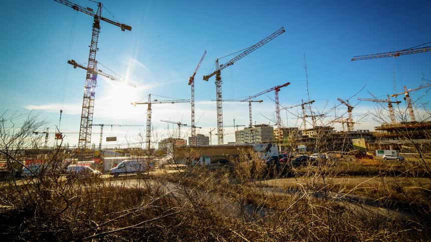 A lot of cranes are working in a timelapse video