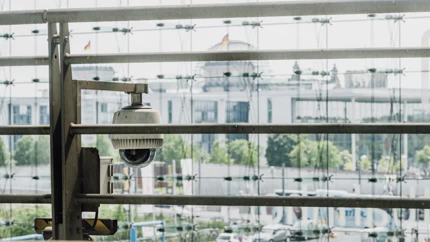 Security Camera next to a large window with cars passing by outside
