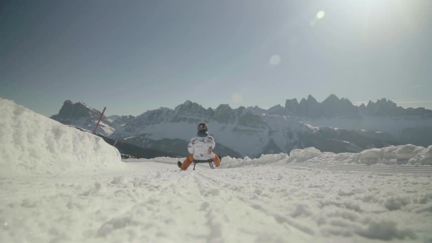 A luge rider descends down the slope