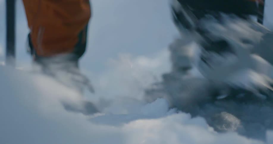A hiker climbs with snowshoes