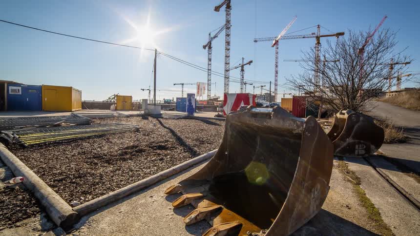 Cranes rotate on a worksite