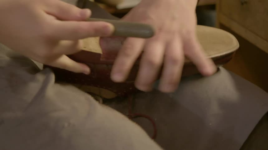 A person files down a shoe heel