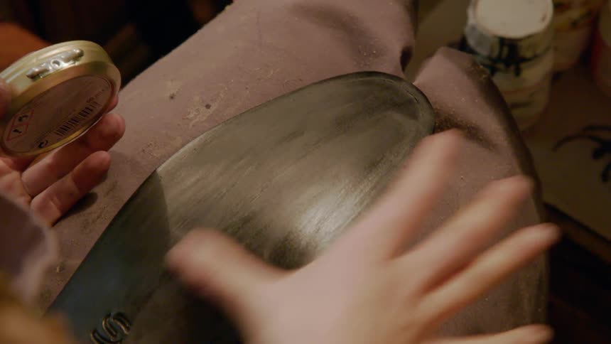 Woman rubbing wax on a shoe sole