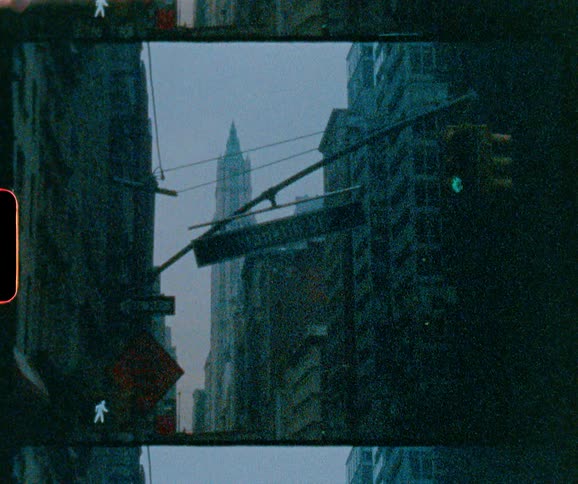 A street sign hangs above a city street