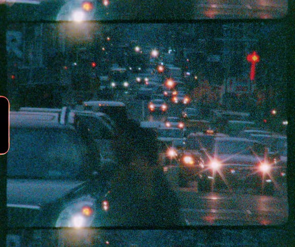 The busy city street is full of stopped cars