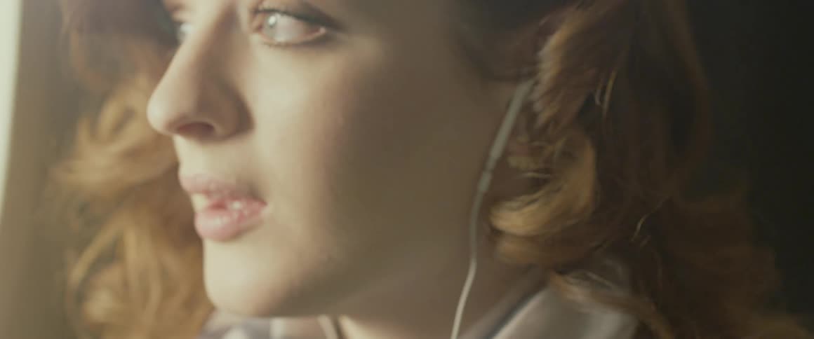 A woman listens to headphones