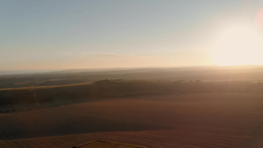 The sun shines on open agricultural land