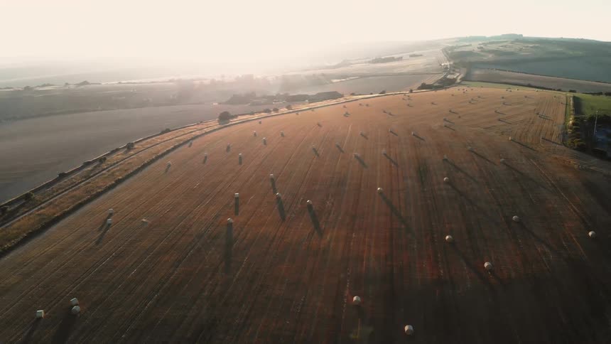 The farm is lined with a fence and hay all over