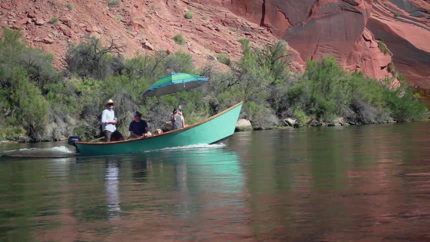 People ride in a green boat