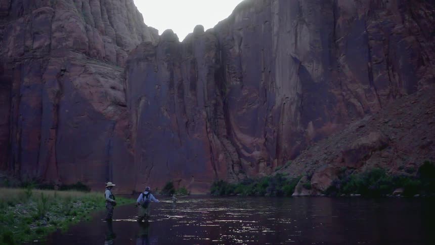 Two men are fishing in a canyon
