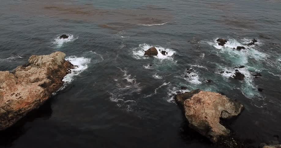 Waves are crashing around rocks