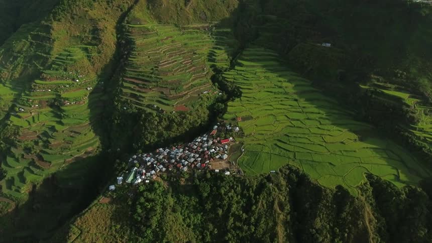 A small village is nestled on a lush green hill side