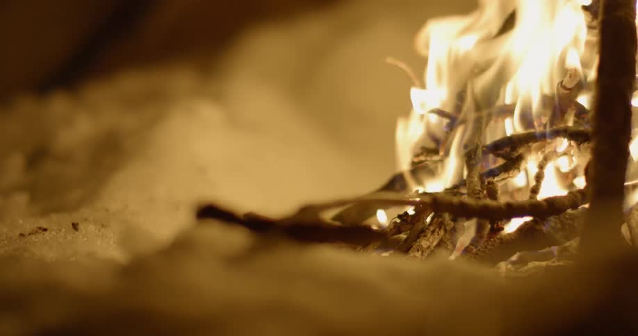 A fire is built in the snow
