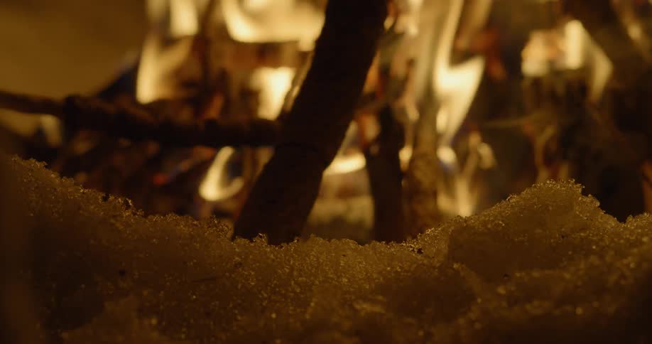 The fire is melting the snow around it