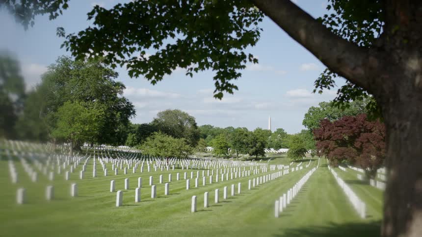 Headstones are displayed symmetrically in a cemetery