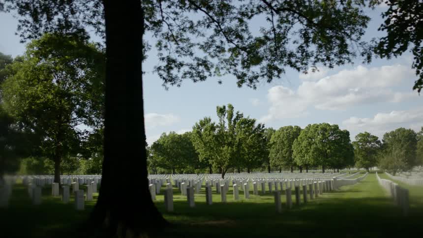 Headstones are arranged in rows in a cemetery