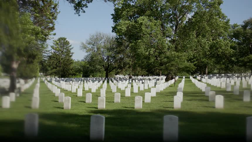 Headstones are displayed symmetrically in a cemetery