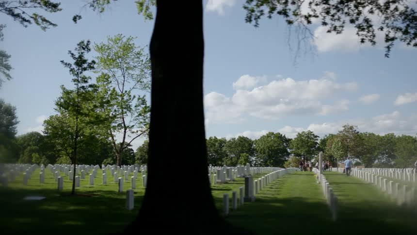 Headstones are displayed symmetrically in a cemetery