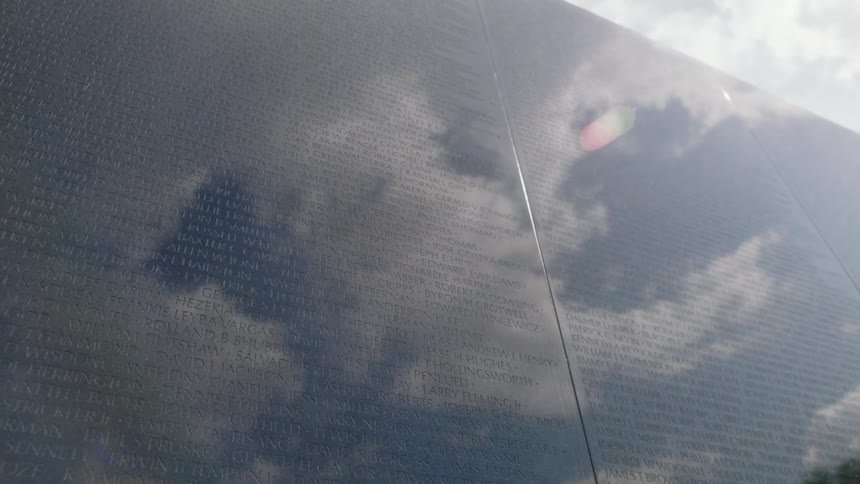 Clouds are reflected on a memorial wall