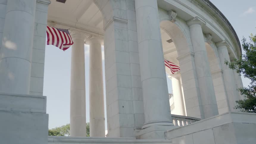 Close up of american flags blowing inside a monument