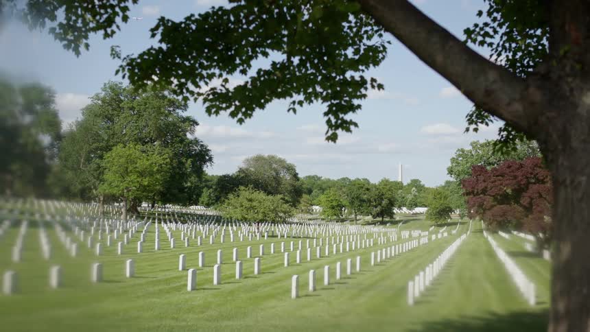 Headstones are displayed symmetrically in a cemetery