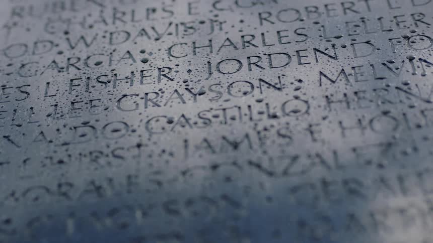 Sunlight and shadow on a memorial with people's names etched on it