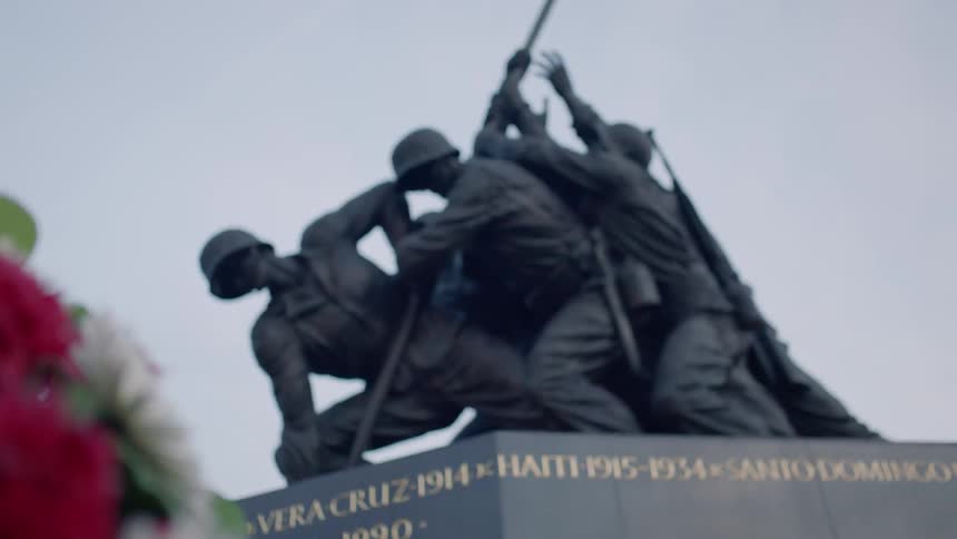 Flowers are next to a war monument