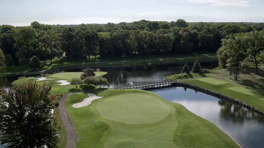 A golf course with a man made lake