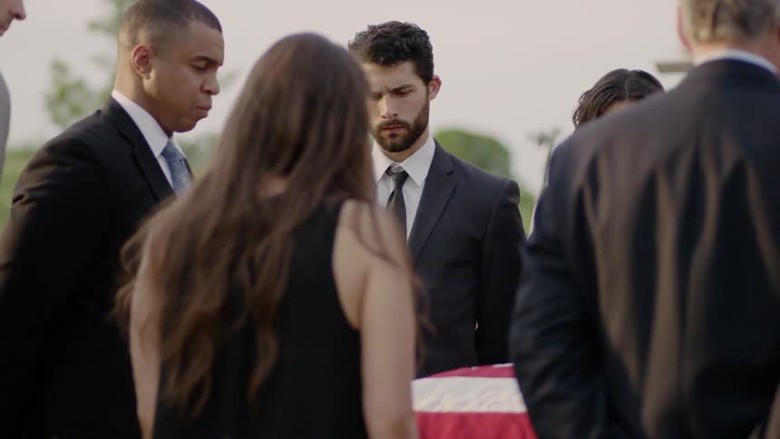People grieve at a funeral service