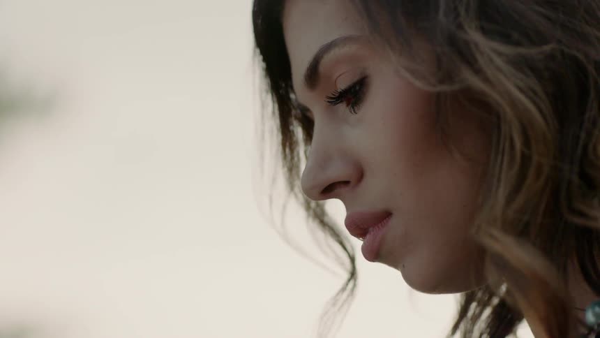 A woman looks sad outdoors