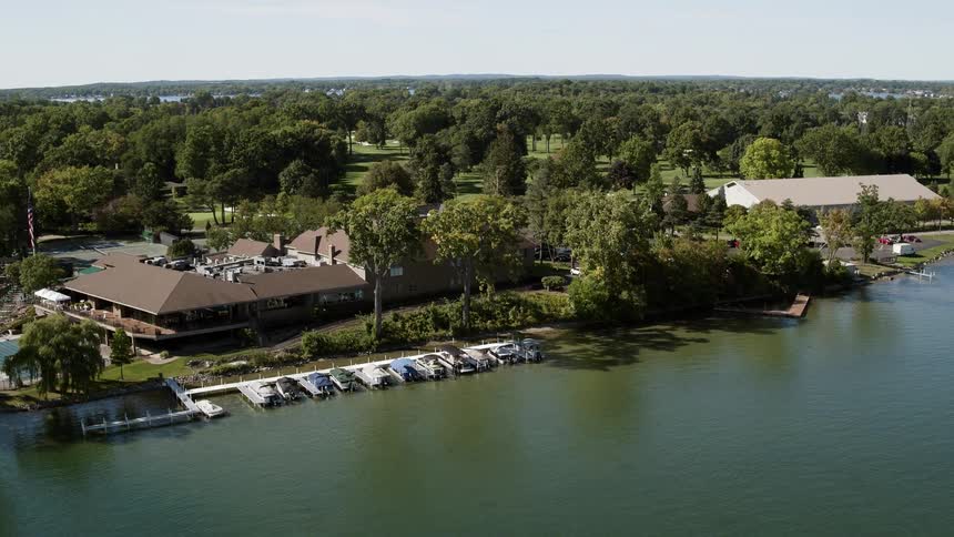 Boats sit docked near a clubhouse building