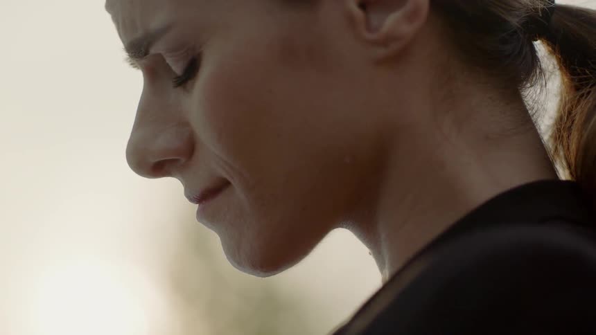 A woman cries and closes her eyes