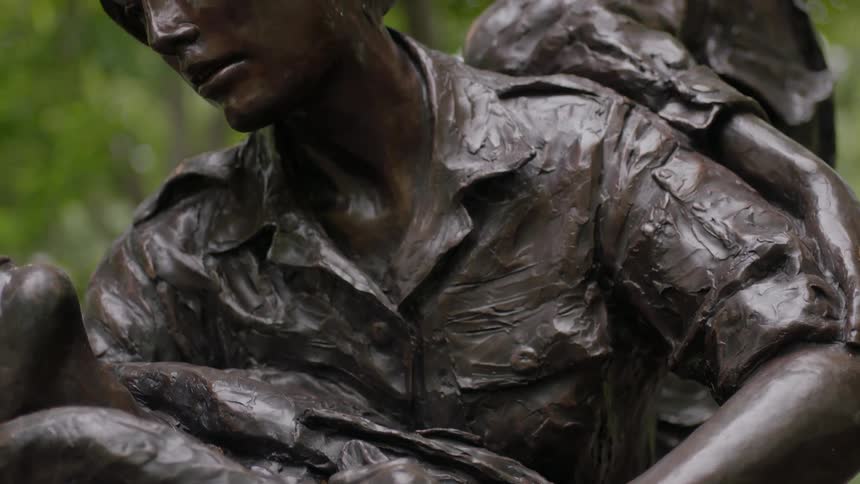 A war memorial statue is displayed outside