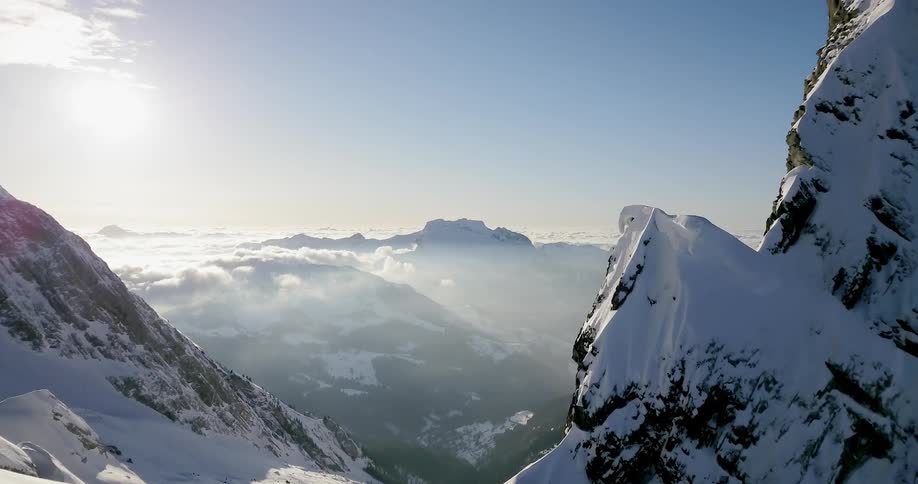 Snow covers the top of towering mountains