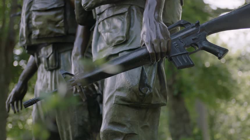 A bronze statue of two soldiers holding guns