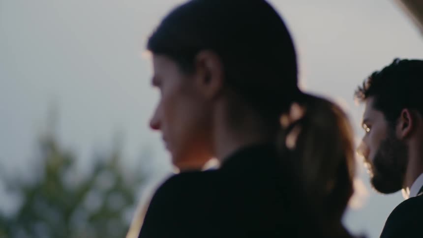 A man and woman grieve at a funeral