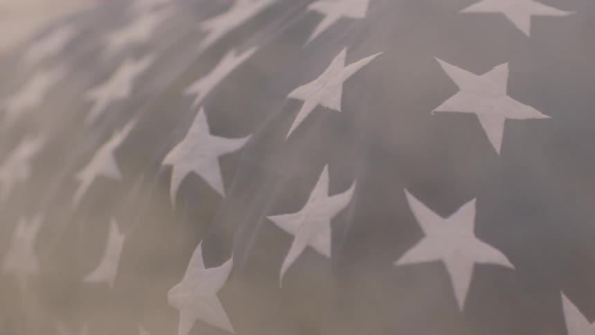 A flag is having dust blown against it